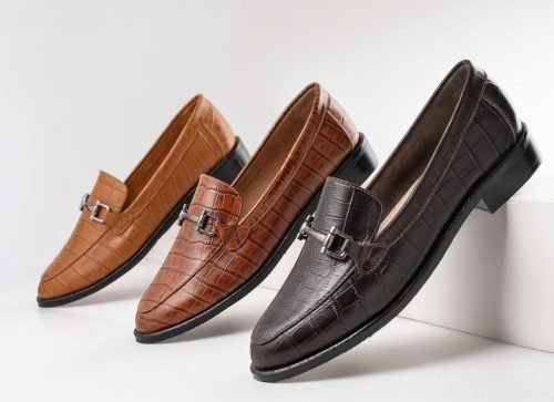 Three pair of elegant leather moccasins in brown tones showcased on a white background.